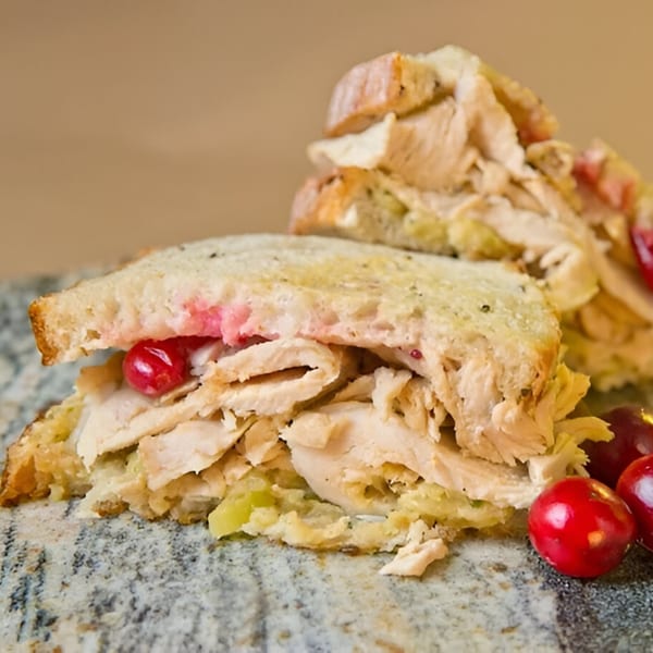 A Beantown Pastrami deli sandwich with turkey, stuffing, and cranberries on toasted bread.